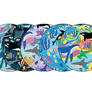May include: Five colorful round placemats with a sea life theme. Each placemat features a different assortment of sea creatures, including whales, sharks, seahorses, and fish. The placemats are perfect for adding a touch of whimsy to any dining table.