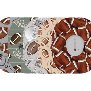 May include: A collection of patterned adhesive patches featuring footballs, play diagrams, and the text "LET'S GO BOYS!". The patches have a brown, gray, and tan color scheme, with a circular device in the center.