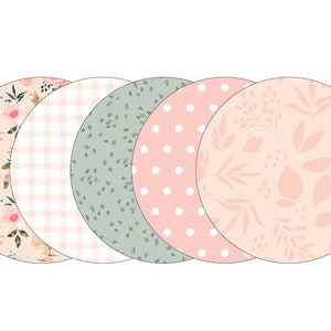 May include: Set of five round paper plates with different pastel floral patterns. The plates feature a pink gingham pattern, a green leaf pattern, a pink polka dot pattern, a pink floral pattern, and a pink floral pattern with a bunny.