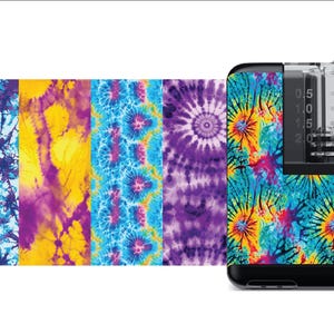 May include: A tie-dye patterned skin for a small, clear, plastic, medical device with a black base and a graduated scale in milliliters. The scale reads from 0 to 2.5 ml.
