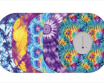 May include: Five different colorful tie-dye designs for a Dexcom G6 continuous glucose monitor. The designs are blue, yellow, purple, and a combination of blue, yellow, and purple.