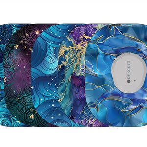 May include: A collection of decorative adhesive patches with various designs. The patches feature swirling blue and purple patterns, gold accents, and a dolphin motif. One patch has a white Dexcom sensor.