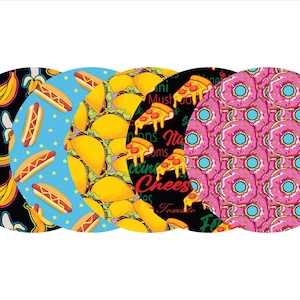 May include: Five circular designs with food patterns. The designs include bananas on black, hot dogs on blue, tacos on yellow, pizza on black, and pink donuts. The pizza design has text.