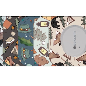 May include: A medical device with a camping-themed design. The design features bears, mountains, tents, and campfires in various colors. The device has a gray circular component with the word "dexcom" printed on it.