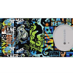 May include: A rectangular, patterned sticker with a BMX theme. The design features BMX riders, graffiti-style text, and a gray circular object with the text "dexcom". Colors include black, blue, green, and orange.