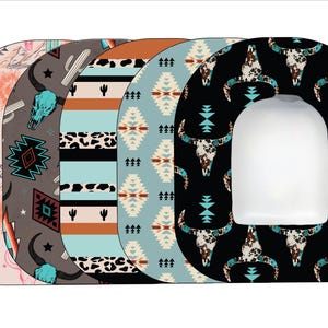 May include: Set of five toilet seat covers with different southwestern patterns. The patterns include a turquoise and brown geometric design, a black and white animal print, a turquoise and brown striped design, a turquoise and brown geometric design, and a black design with white animal skulls.