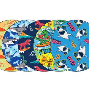 May include: Five circular designs with a surfing theme. The designs feature dinosaurs and sharks wearing sunglasses, riding surfboards, and the text "Catch the Waves" and "Vibe". The color palette includes blue, green, yellow, and red.