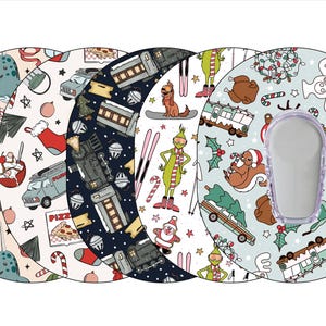 May include: A collection of five round, patterned items, each featuring a different holiday-themed design. The designs include characters and elements from popular Christmas movies, such as the Grinch and Elf, along with festive motifs like narwhals, trains, and candy canes.