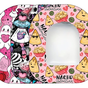 May include: A pink and black patterned sticker with a white cutout in the center. The sticker features a cartoon design of a nacho chip with a face and sunglasses. The text "Nacho Valentine" is printed on the sticker.