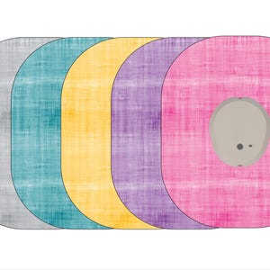 May include: Five round fabric coasters in gray, teal, yellow, purple, and pink. The coasters have a textured surface and a small round hole in the center.