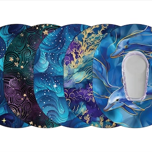 May include: Set of four round stickers featuring different blue and purple designs with gold accents. One sticker features a galaxy design with stars, another has a swirling wave pattern, a third has a coral reef design, and the last sticker features two dolphins swimming in the ocean.