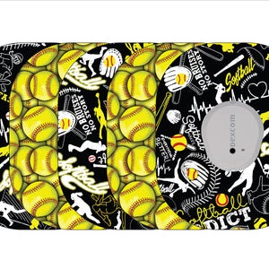 May include: A black and yellow softball-themed medical device cover. The design includes yellow softballs, silhouettes of players, bats, and gloves. Text includes "Softball," "No Bruises No Story," and "Everything Makes Better!"