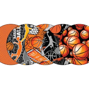 May include: Five round orange and black basketball-themed coasters with different designs. One coaster features a basketball with a textured surface, another has a basketball player silhouette, another has a basketball court, another has a basketball net, and the last one has a pattern of basketballs.
