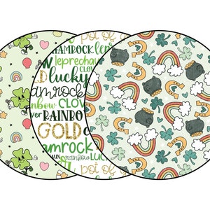 May include: Three green, white, and gold patterned circles with a shamrock, rainbow, and pot of gold design. The text "Shamrock Leprechaun Lucky" is written on the circle in the middle.
