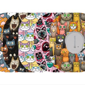 May include: A patterned medical device cover featuring a collage of cartoon cats in various colors and expressions. The design includes cats with different eye colors, and some with tattoo-style elements. A gray circular device is visible on the right side.