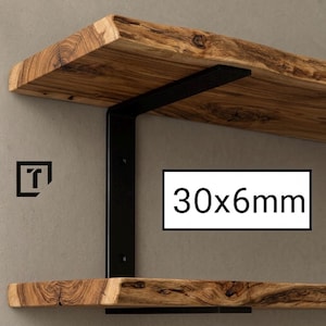 Può includere: Due mensole in legno con bordo naturale sono sostenute da staffe in metallo nero. Le staffe sono fissate al muro. Il testo "30x6mm" è visualizzato in un rettangolo bianco.