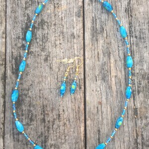 Blue and yellow swirled glass and iridescent blue seed bead necklace and earring set.