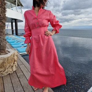 Women&#39;s long loose linen dress with a wide belt, ruffle on the collar and sleeves.