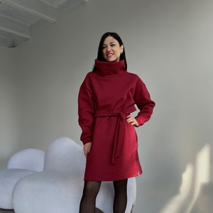 Red dress. Women&#39;s warm dress made of warm cotton fleece with a belt. Sweatshirt Dress