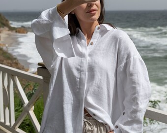 White women's long linen oversized shirt. Loose-fitting blouse made of washed linen. Loose women's linen shirt with wide sleeves