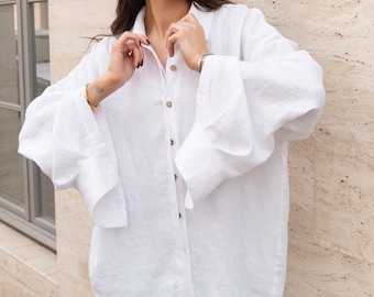 White women's long linen oversized shirt. Loose-fitting blouse made of washed linen. Loose women's linen shirt with wide sleeves