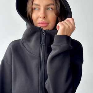 Romper with pockets. Women&#39;s warm jumpsuit made of warm cotton fleece with a hoodie.