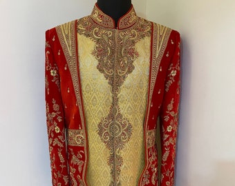 May include: A red and gold embroidered jacket with a mandarin collar. The jacket is decorated with intricate floral patterns and sequins.