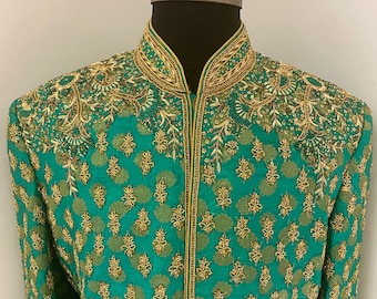 May include: A green jacket with gold embroidery. The jacket has a mandarin collar and a zip closure.