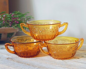 Vintage amber glass soup bowls / Indiana Glass daisy pattern #920 / three vintage amber pressed floral glass berry bowls / two handle bowl