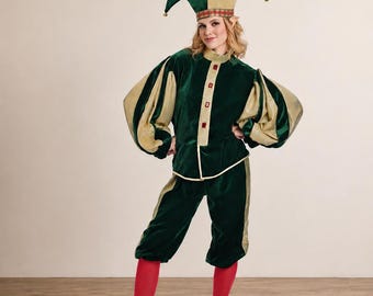 May include: A velvet jester costume featuring a dark green and gold color scheme. The outfit includes a long-sleeved jacket with puffed sleeves, matching knee-length breeches, a two-pointed jester hat, bright red leggings, and gold pointed shoes.