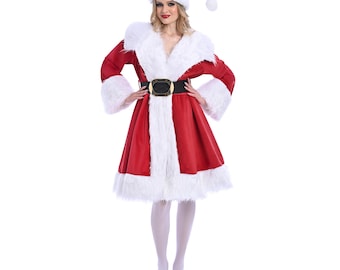May include: A red Santa Claus costume with white faux fur trim. The outfit includes a dress, hat, and belt with a gold buckle. The dress has long sleeves and a flared skirt. The model is wearing white tights and red shoes.