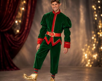 May include: A green velvet elf costume featuring a long-sleeved tunic with red trim, a matching red belt with a gold buckle, green trousers, and a pointed green hat. The outfit is paired with metallic gold curled-toe shoes and striped socks.