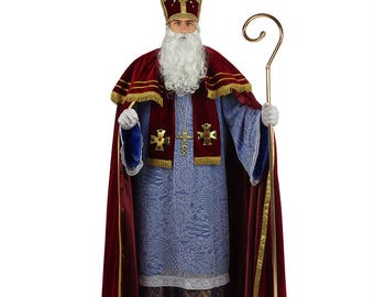 May include: A red and gold bishop's costume with a long, flowing robe, a mitre hat, and a staff. The costume is decorated with gold trim and crosses.