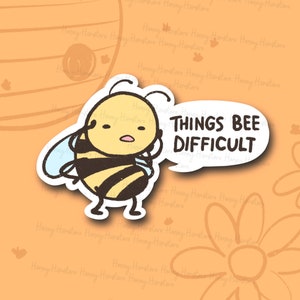 May include: A cartoon bee with a speech bubble that says "Things bee difficult". The bee is yellow and black with a white background.