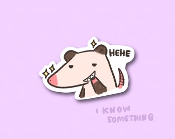 May include: A cartoon illustration of a possum with a mischievous grin, winking and with a sparkle above its head. The possum is saying "HEHE I KNOW SOMETHING."