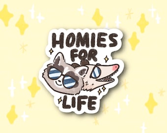 May include: A sticker featuring a raccoon and an opossum wearing sunglasses with the text "Homies for Life".