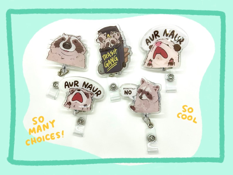 May include: Five different colourful plastic badge holders with cartoon raccoon designs. The designs include a raccoon with the text "Trash Gang", a raccoon with the text "Aur Naur", a raccoon with the text "Respectfully No", and two raccoons with the text "Aur Naur".