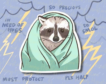 May include: A cartoon raccoon wrapped in a light blue blanket with the text "IN NEED OF HUGS" and "SO PRECIOUS" above the raccoon and "SO SMOL" and "MUST PROTECT PLS HALP" below the raccoon.