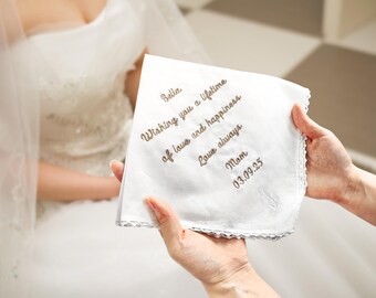May include: White embroidered handkerchief with the text "Bella. Wishing you a lifetime of love and happiness. Love always. Mom. 03.09.23"