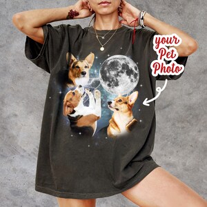 May include: A dark gray oversized t-shirt with a graphic print of three dogs howling at the moon. The text "your pet photo" is in a red circle with an arrow pointing to the moon.