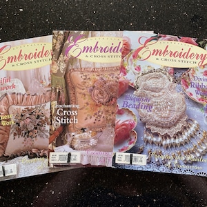 May include: Four copies of "Australian Embroidery & Cross Stitch" magazines are shown. The covers display detailed embroidery projects, including blackwork, cross stitch, and beading. The magazines showcase various techniques and designs.
