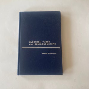 May include: A navy blue hardback book titled "Electron Tubes and Semiconductors" by Joseph J. DeFrance.