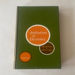 May include: A hardcover book titled "Applications of Electronics" by Bernard Grob & Milton S. Kiver. The cover is olive green with orange and white circular graphics. The words "Second Edition" are also visible.