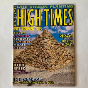 May include: A copy of High Times magazine with the title in large yellow letters against a blue sky background. The cover features a pyramid-shaped structure made of plant material. Text includes "Pot Travel Tips" and "Dixie Fried".