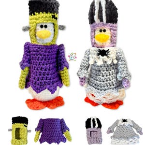 May include: Two crocheted penguin ornaments dressed up for Halloween. One is a Frankenstein's monster with a purple dress and green skin. The other is a vampire with a gray dress and black and white striped hat.
