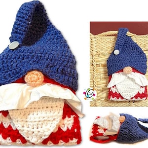 May include: A crocheted gnome-shaped tissue box cover with a blue hat, white beard, and red and white patterned body. The cover has a loop for hanging.