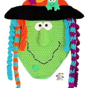 May include: A green crocheted witch face with a black witch hat, orange and blue braids, and a green frog on the hat.
