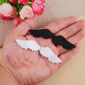 May include: A set of three ceramic vases in varying sizes. The vases are white with a textured, ribbed design. The tallest vase is approximately 10 inches tall. The other two are slightly smaller, creating a tiered display.