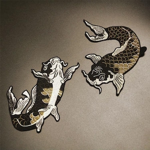 May include: Two black and white embroidered koi fish patches. The fish are facing opposite directions. The fish have gold scales and white accents.