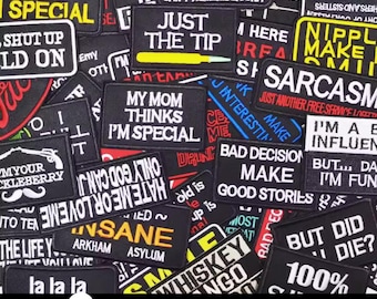May include: A collection of black iron-on patches with various humorous and sarcastic sayings. The patches feature white, red, yellow, and blue lettering. Some of the sayings include "I'm Special", "Just the Tip", "Bad Decision Make Good Stories", and "But Did I Die?"